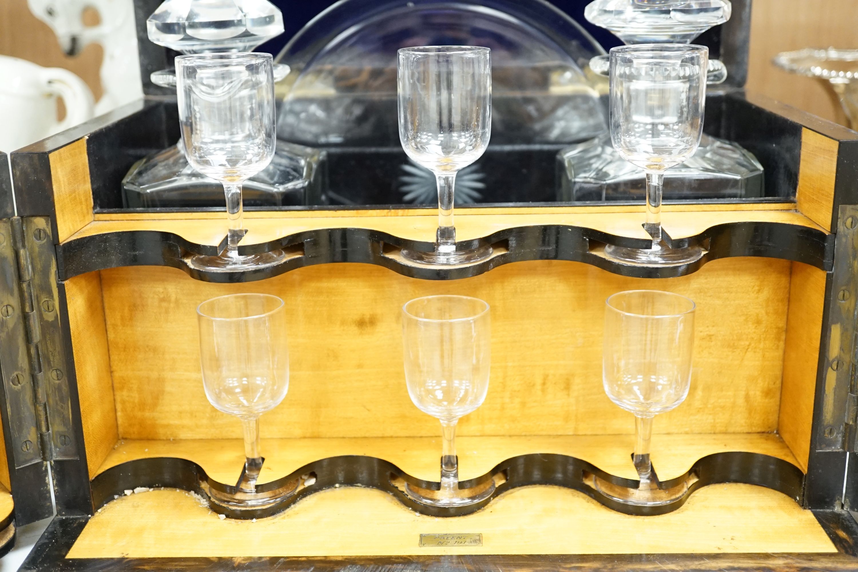 A Victorian coromandel wood two door decanter box, with two decanters and six glasses, 24cm high x 33cm wide